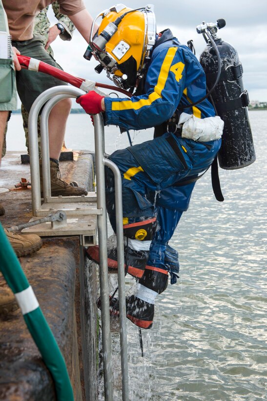 Navy Petty Officer 1st Class Spencer Puett climbs out of the Savannah River after completing salvage operations on CSS Georgia steamship in Savannah, Ga., Aug. 18, 2015. Puett is a diver assigned to Mobile Diving and Salvage Unit 2. U.S. Navy photo by Petty Officer 1st Class Blake Midnight 