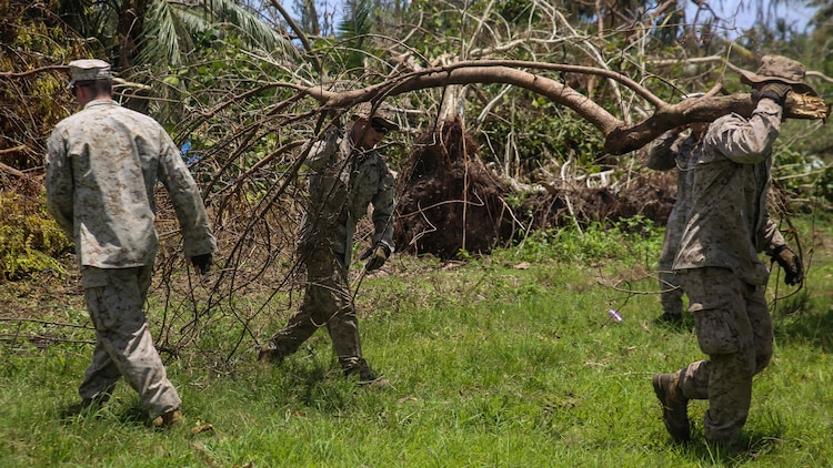 U.S. Marines clear debris at a high school as part of a typhoon relief mission in Saipan Aug. 12, 2015 The Marines with Echo Company, Battalion Landing Team 2nd Battalion, 5th Marines, 31st Marine Expeditionary Unit and Combat Logistics Battalion 31, 31st MEU, assisted the locals of Saipan by clearing debris from several schools. The Marines and sailors of the 31st MEU were conducting training near the Mariana Islands when they were redirected to Saipan after the island was struck by Typhoon Soudelor Aug. 2-3. 