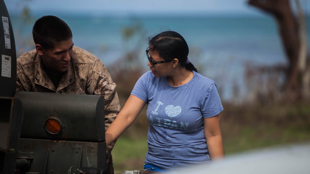 U.S. Marine Lance Cpl. Andy Larsen, with Combat Logistics Battalion 31, 31st Marine Expeditionary Unit, helps distribute water to local civilians during typhoon relief efforts in Saipan, Aug. 13, 2015. The Marines with Echo Company, Battalion Landing Team 2nd Battalion, 5th Marines, 31st MEU and CLB 31, 31st MEU, are aiding the locals of Saipan by producing and distributing potable water. The Marines and sailors of the 31st MEU were conducting training near the Mariana Islands when they were redirected to Saipan after the island was struck by Typhoon Soudelor Aug. 2-3.