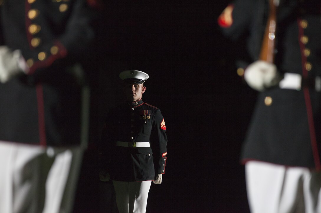The Silent Drill Platoon performs during an evening parade at Marine  Barracks Washington, D.C., Aug. 21, 2015. The Honorable Mr. Andy Berke, Mayor of Chattanooga, The Honorable Earl Anthony ‘Tony’ Reavley, Director of Hamilton County Emergency Services & Homeland Security, and The Honorable Mr. Fred Fletcher, Chief of Police, Chattanooga Police Department, were the guests of honor for the parade at Marine Barracks Washington, D.C., and U.S. Marine Corps Lt. Gen. Richard P. Mills, Commander of Marine Forces Reserve, Marine Forces North, was the hosting official for that same parade.  The Evening Parade summer tradition began in 1934 and features the Silent Drill Platoon, the U.S. Marine Band, the U.S. Marine Drum and Bugle Corps and two marching companies. More than 3,500 guests attend the parade every week. (U.S. Marine Corps photo by Lance Cpl. Alex A. Quiles/Released)
