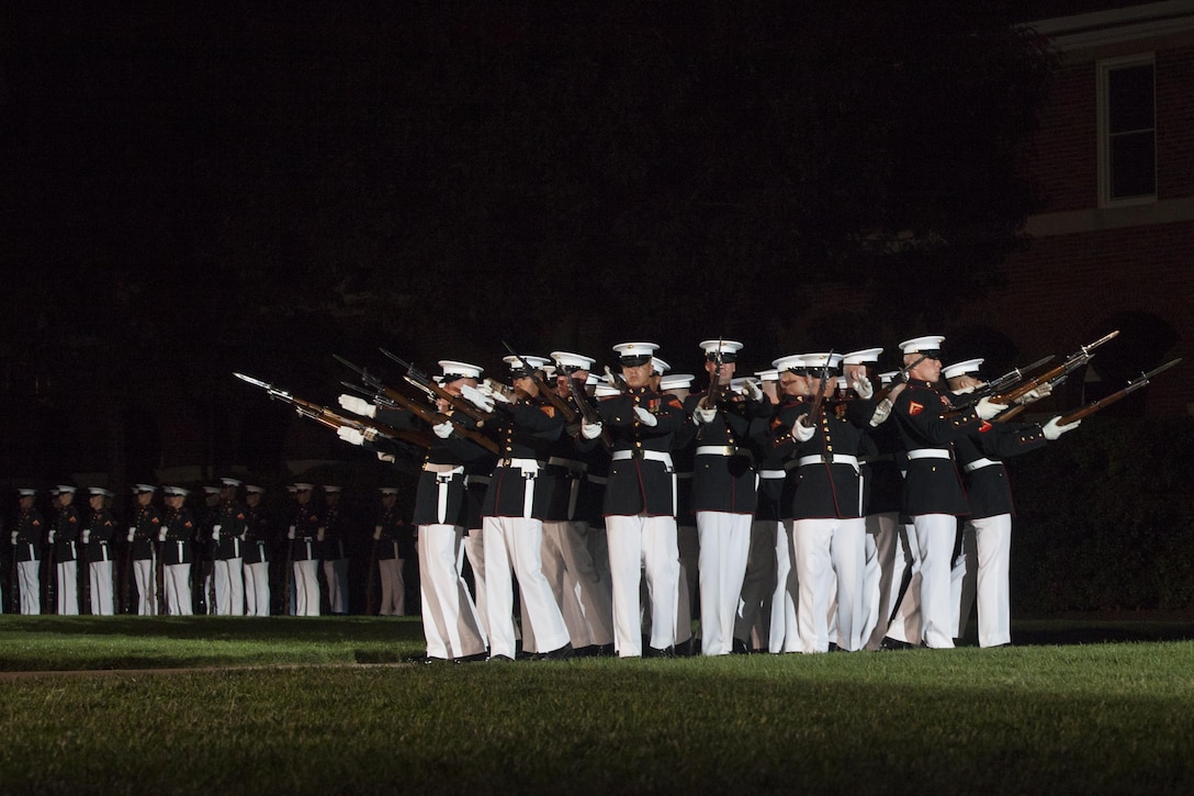 The Silent Drill Platoon performs during an evening parade at Marine  Barracks Washington, D.C., Aug. 21, 2015. The guests of honor for the evening parade was The Honorable Mr. Fred Fletcher, chief of police, Chattanooga Police Department, The Honorable Mr. Earl Anthony Reavley, director of Hamilton County Emergency Services & Homeland Security, and The Honorable Mr. Andy Berke, mayor of Chattanooga, Tenn., and the hosting official was Lt. Gen. Richard P. Mills, commander of Marine Forces Reserve, and Marine Forces North. (U.S. Marine Corps photo by Lance Cpl. Kayla V. McTaw/Released)