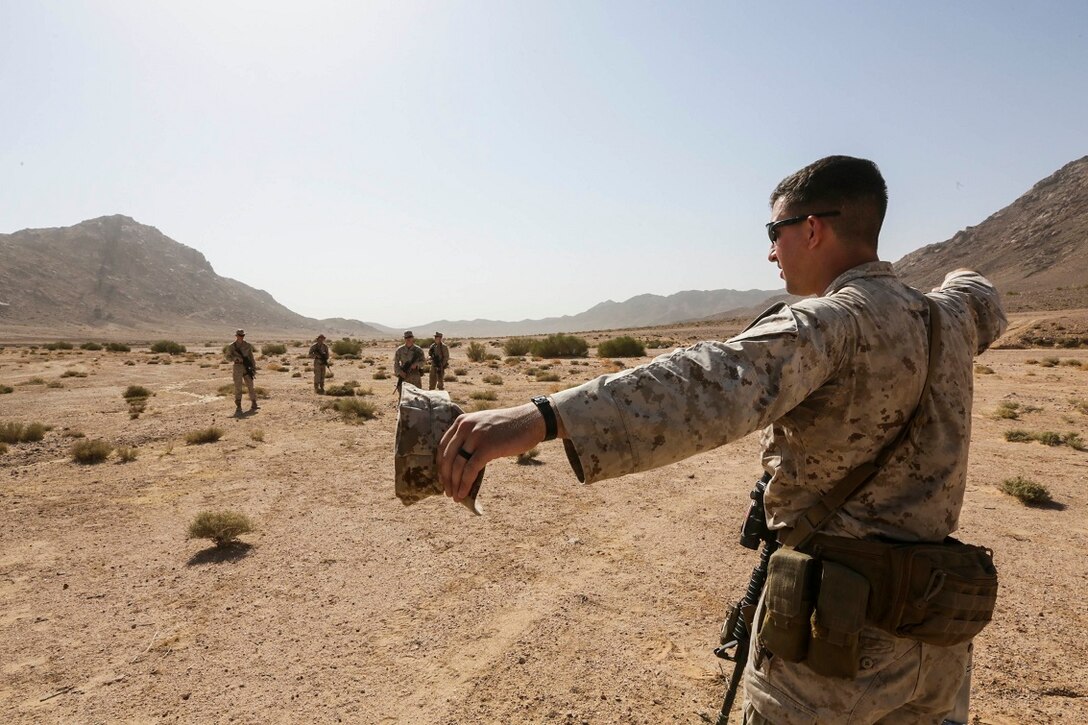Southwest Asia (Aug. 18, 2015) U.S. Marine Sgt. Ryan Jackson gives hand-and-arm signals to his Marines during immediate action drills.  Jackson is a squad leader with India Company, Battalion Landing Team 3rd Battalion, 1st Marine Regiment, 15th Marine Expeditionary Unit. The 15th MEU is deployed throughout Southwest Asia to maintain regional security in the U.S. 5th Fleet area of operations. (U.S. Marine Corps photo by Sgt. Jamean Berry/Released)