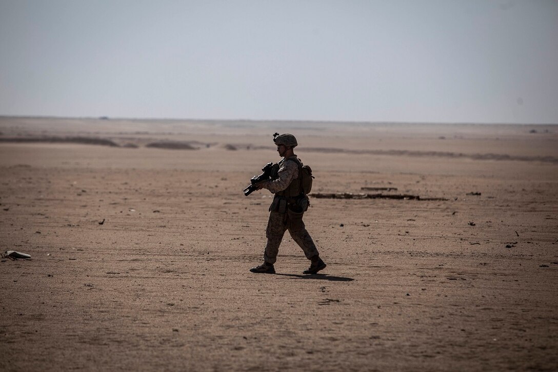 A U.S. Marine with Lima Company, Battalion Landing Team 3rd Battalion, 1st Marine Regiment, 15th Marine Expeditionary Unit (MEU), patrols to his next objective during squad-level training. Elements of the 15th MEU are ashore in Kuwait for sustainment training to maintain and enhance the skills they developed during their pre-deployment training period.  The 15th MEU is embarked on the Essex Amphibious Ready Group and deployed to maintain regional security in the U.S. 5th Fleet area of operations. (U.S. Marine Corps photo by Cpl. Elize McKelvey/Released)