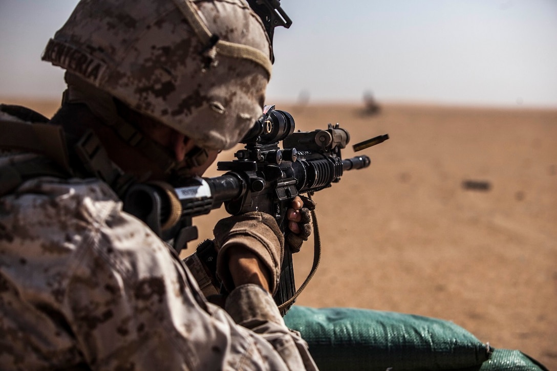 A U.S. Marine with Lima Company, Battalion Landing Team 3rd Battalion, 1st Marine Regiment, 15th Marine Expeditionary Unit (MEU), fires rounds at a target with his M27 infantry automatic rifle during squad-level training. Elements of the 15th MEU are ashore in Kuwait for sustainment training to maintain and enhance the skills they developed during their pre-deployment training period.  The 15th MEU is embarked on the Essex Amphibious Ready Group and deployed to maintain regional security in the U.S. 5th Fleet area of operations. (U.S. Marine Corps photo by Cpl. Elize McKelvey/Released)