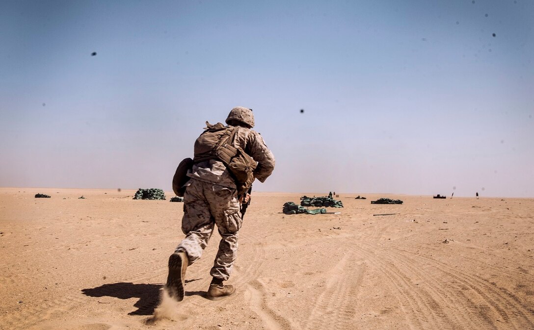 A U.S. Marine with Lima Company, Battalion Landing Team 3rd Battalion, 1st Marine Regiment, 15th Marine Expeditionary Unit (MEU), sprints to his next objective point during squad-level training. Elements of the 15th MEU are ashore in Kuwait for sustainment training to maintain and enhance the skills they developed during their pre-deployment training period.  The 15th MEU is embarked on the Essex Amphibious Ready Group and deployed to maintain regional security in the U.S. 5th Fleet area of operations. (U.S. Marine Corps photo by Cpl. Elize McKelvey/Released)