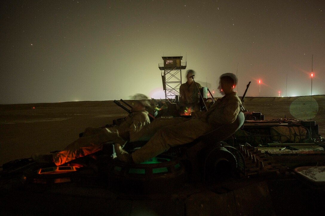 KUWAIT (Aug. 19, 2015) U.S. Marines with Kilo Company, Battalion Landing Team 3rd Battalion, 1st Marine Regiment, 15th Marine Expeditionary Unit (MEU), observe a night live-fire and maneuver exercise. During the training, Marines used night vision devices to engage targets with the Browning .50 caliber machine gun at unknown distances from AAV-7 Amphibious Assault Vehicles. Elements of the 15th MEU are ashore in Kuwait for sustainment training to maintain and enhance the skills they developed during their pre-deployment training period.  The 15th MEU is embarked on the Essex Amphibious Ready Group and deployed to maintain regional security in the U.S. 5th Fleet area of operations. (U.S. Marine Corps photo by Sgt. Emmanuel Ramos/Released)