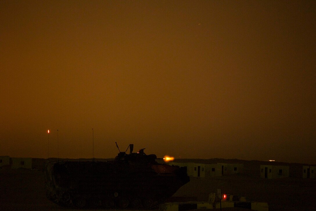 KUWAIT (Aug. 19, 2015) U.S. Marines with Kilo Company, Battalion Landing Team 3rd Battalion, 1st Marine Regiment, 15th Marine Expeditionary Unit (MEU), engage targets during a night live-fire and maneuver exercise. During the training, Marines used night vision devices to engage targets with the Browning .50 caliber machine gun at unknown distances from Amphibious Assault Vehicles (AAV-7). Elements of the 15th MEU are ashore in Kuwait for sustainment training to maintain and enhance the skills they developed during their pre-deployment training period.  The 15th MEU is embarked on the Essex Amphibious Ready Group and deployed to maintain regional security in the U.S. 5th Fleet area of operations. (U.S. Marine Corps photo by Sgt. Emmanuel Ramos/Released)
