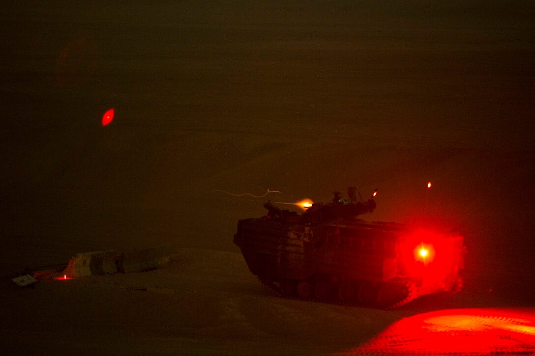 KUWAIT (Aug. 19, 2015) U.S. Marines with Kilo Company, Battalion Landing Team 3rd Battalion, 1st Marine Regiment, 15th Marine Expeditionary Unit (MEU), engage targets during a night live-fire and maneuver exercise. During the training, Marines used night vision devices to engage targets with the Browning .50 caliber machine gun at unknown distances from Amphibious Assault Vehicles (AAV-7). Elements of the 15th MEU are ashore in Kuwait for sustainment training to maintain and enhance the skills they developed during their pre-deployment training period.  The 15th MEU is embarked on the Essex Amphibious Ready Group and deployed to maintain regional security in the U.S. 5th Fleet area of operations. (U.S. Marine Corps photo by Sgt. Emmanuel Ramos/Released)