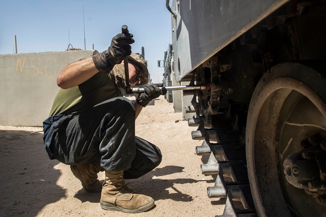 KUWAIT (Aug. 22, 2015) U.S. Marine Lance Cpl. John Figueroa checks the suspension on an Amphibious Assault Vehicle (AAV-7). Figueroa is a crewman with Kilo Company, Battalion Landing Team 3rd Battalion, 1st Marine Regiment, 15th Marine Expeditionary Unit (MEU). These Marines maintain the AAVs to ensure they remain in good condition and are operable in extreme environments. Elements of the 15th MEU are ashore in Kuwait for sustainment training to maintain and enhance the skills they developed during their pre-deployment training period.  The 15th MEU is embarked on the Essex Amphibious Ready Group and deployed to maintain regional security in the U.S. 5th Fleet area of operations. (U.S. Marine Corps photo by Sgt. Emmanuel Ramos/Released)