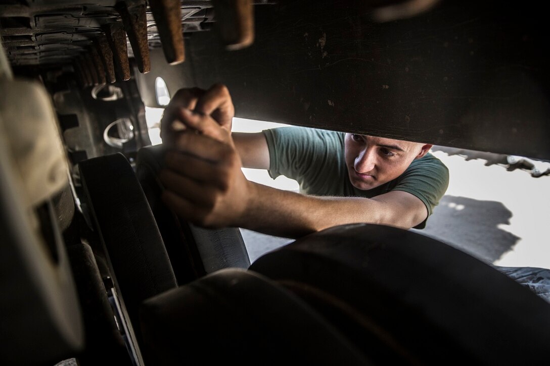 KUWAIT (Aug. 22, 2015) U.S. Marine Cpl. Stephen Hill checks the suspension on an on an Amphibious Assault Vehicle (AAV-7). Hill is a crew chief with Kilo Company, Battalion Landing Team 3rd Battalion, 1st Marine Regiment, 15th Marine Expeditionary Unit (MEU). These Marines maintain the AAVs to ensure they remain in good condition and are operable in extreme environments. Elements of the 15th MEU are ashore in Kuwait for sustainment training to maintain and enhance the skills they developed during their pre-deployment training period. The 15th MEU is embarked on the Essex Amphibious Ready Group and deployed to maintain regional security in the U.S. 5th Fleet area of operations. (U.S. Marine Corps photo by Sgt. Emmanuel Ramos/Released)