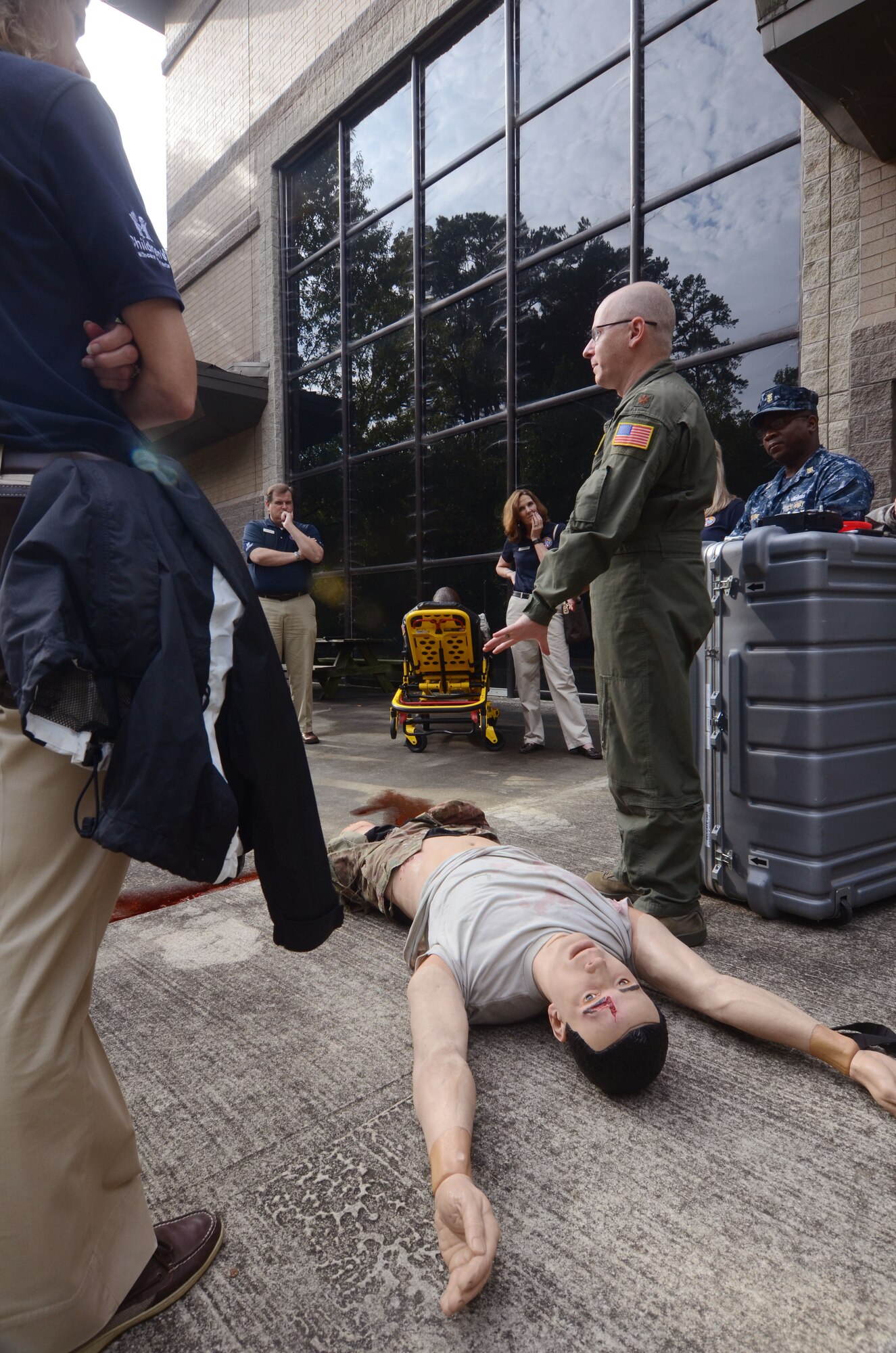 Maj. Chad Corliss, 94th Aeromedical Evacuation Squadron Director of Operations, briefs members of the Honorary Commanders Association on medical training received by reservists assigned to AES atDobbins Air Reserve Base, Ga. Aug 19, 2015. . Corliss also demonstrated functions of real-like mannequins used to prepare medical teams for mission objectives. The HCA visited various units during a Dobbins Day base tour held. 