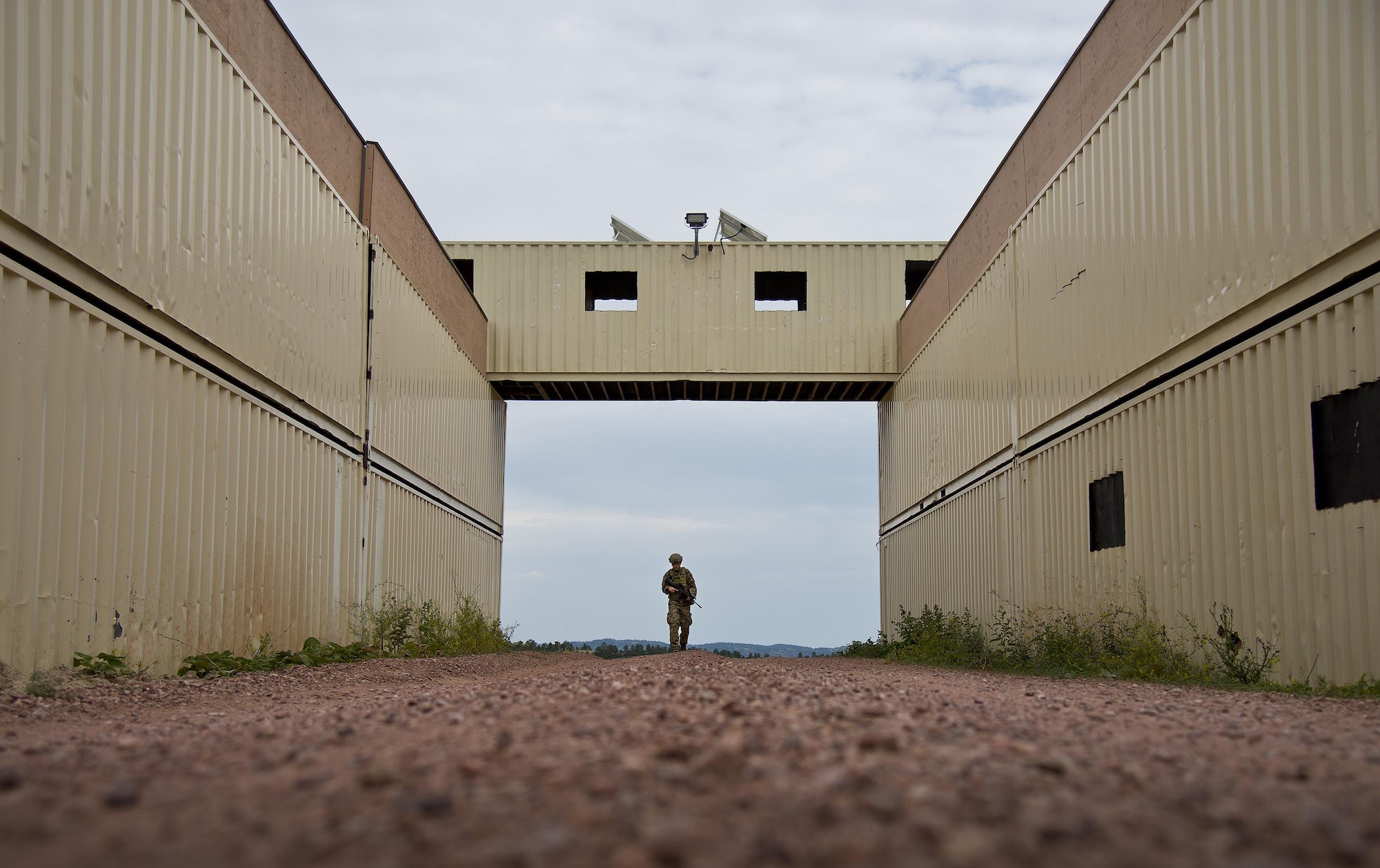 Senior Airman Amanda Smith, 919th Special Operations Security Forces Squadron, walks through the entry way of her two-week home during the squadron’s annual training at Camp Guernsey, Wyo., Aug. 3.  More than 20 Airmen went out West to help train two other Reserve security forces squadrons in ground combat and field training.  The 919th SOSFS Airmen lived in the makeshift camps and acted as opposing forces and local villagers interacting with the occupying security teams. (U.S. Air Force photo/Tech. Sgt. Sam King)