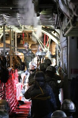 Students of the basic paratrooper course prepare to jump from the 913th Airlift Group’s C-130H during the third and final week of jump school at Fort Benning, Ga. July 13, 2015. To graduate the course students must successfully complete five parachute jumps with the T-11 parachute at 1,250 feet from a C-130 or C-17 aircraft. (U.S. Air Force photo/Maj. Mark Withee)