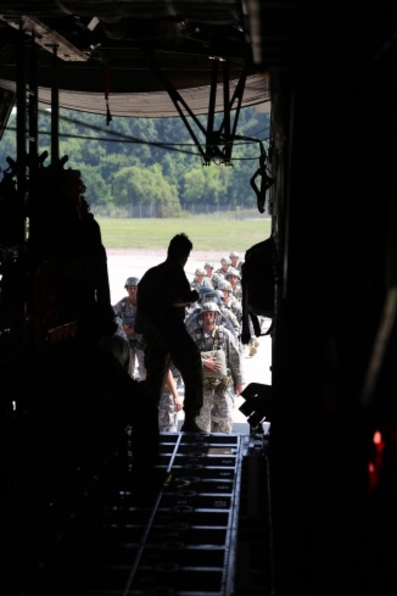 Student paratroopers prepare to board a C-130 aircraft at Fort Benning, Ga. July 13, 2015. Once airborne, students will receive instructions from members of the 1st Battalion, 507th Parachute Infantry Regiment. The 1-507th trains and prepares paratroopers to conduct airborne operations anywhere Department of Defense wide. (U.S. Air Force photo/Maj. Mark Withee)