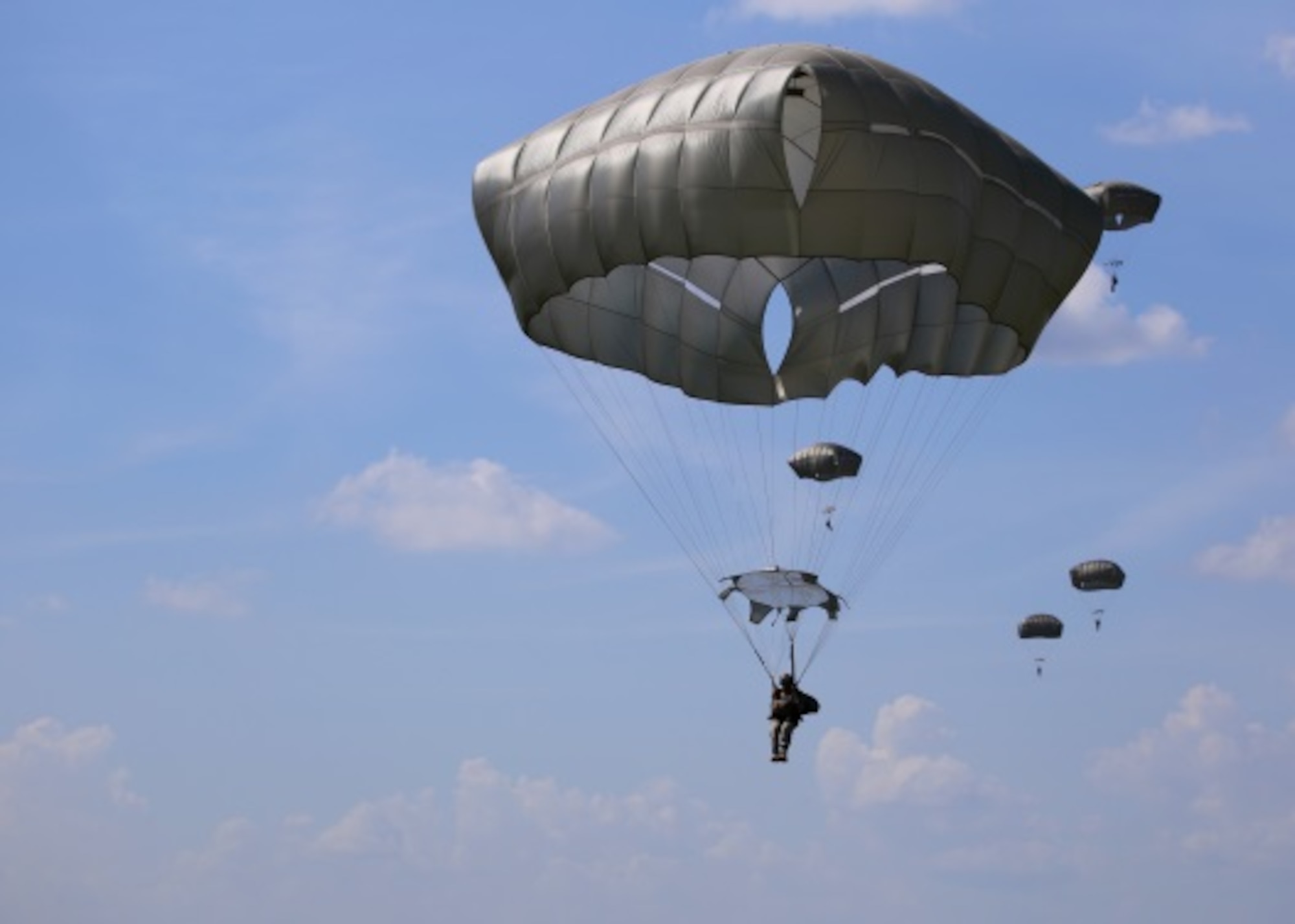 Basic Airborne Course students conduct an airborne jump July 14, 2015 at Fryar Field drop zone in at Fort Benning, Ga. July 13, 2015. The student paratroopers’ jump was supported by aircraft and Total Force crewmembers from the Air Force Reserve’s 913th Airlift Group from Little Rock Air Force Base, Ark. and the 302nd Airlift Wing from Peterson Air Force Base, Col. (U.S. Air Force photo/Maj. Mark Withee)