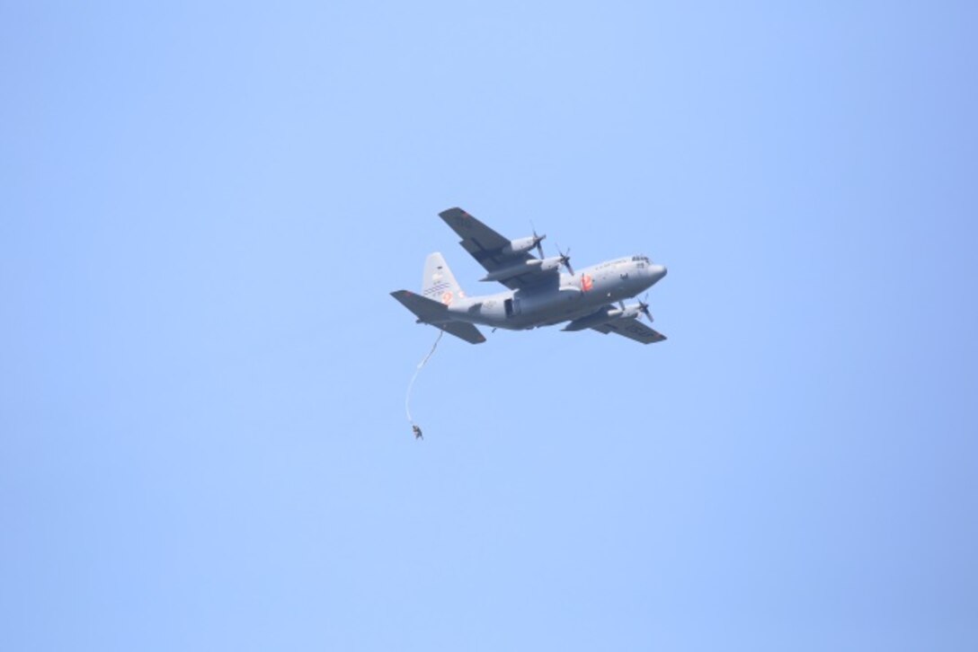 A student paratrooper exits a 302nd Airlift Wing C-130H as part of the Basic Airborne Course at Fort Benning, Ga. July 13, 2015. Students must make five jumps at 1,250 feet from a C-130 or C-17 aircraft during the third and final week of the course. (U.S. Air Force photo/Maj. Mark Withee)