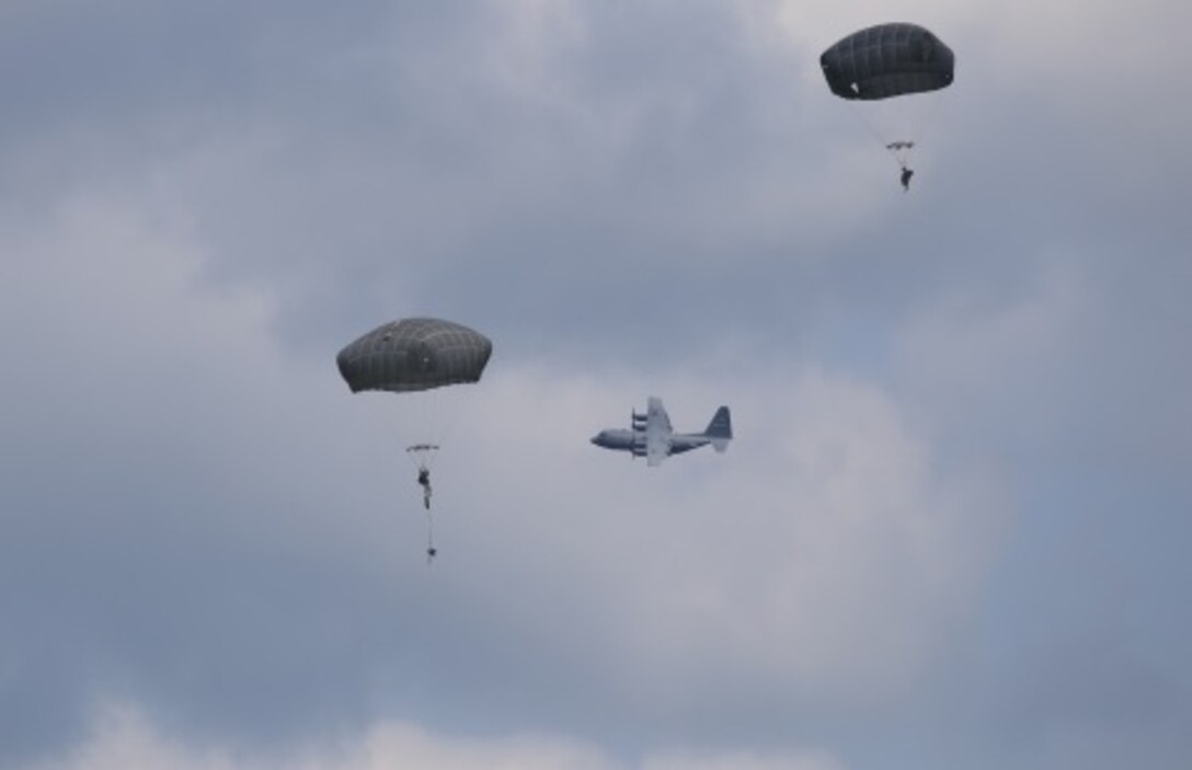 Two student paratroopers descend towards Fryar Field drop zone after jumping from a C-130H at Fort Benning, Ga. July 13, 2015. The students jump was supported by members of the Air Force Reserve’s 913th Airlift Group from Little Rock Air Force Base, Arkansas and the 302nd Airlift Wing from Peterson Air Force Base. (U.S. Air Force photo/Maj. Mark Withee)