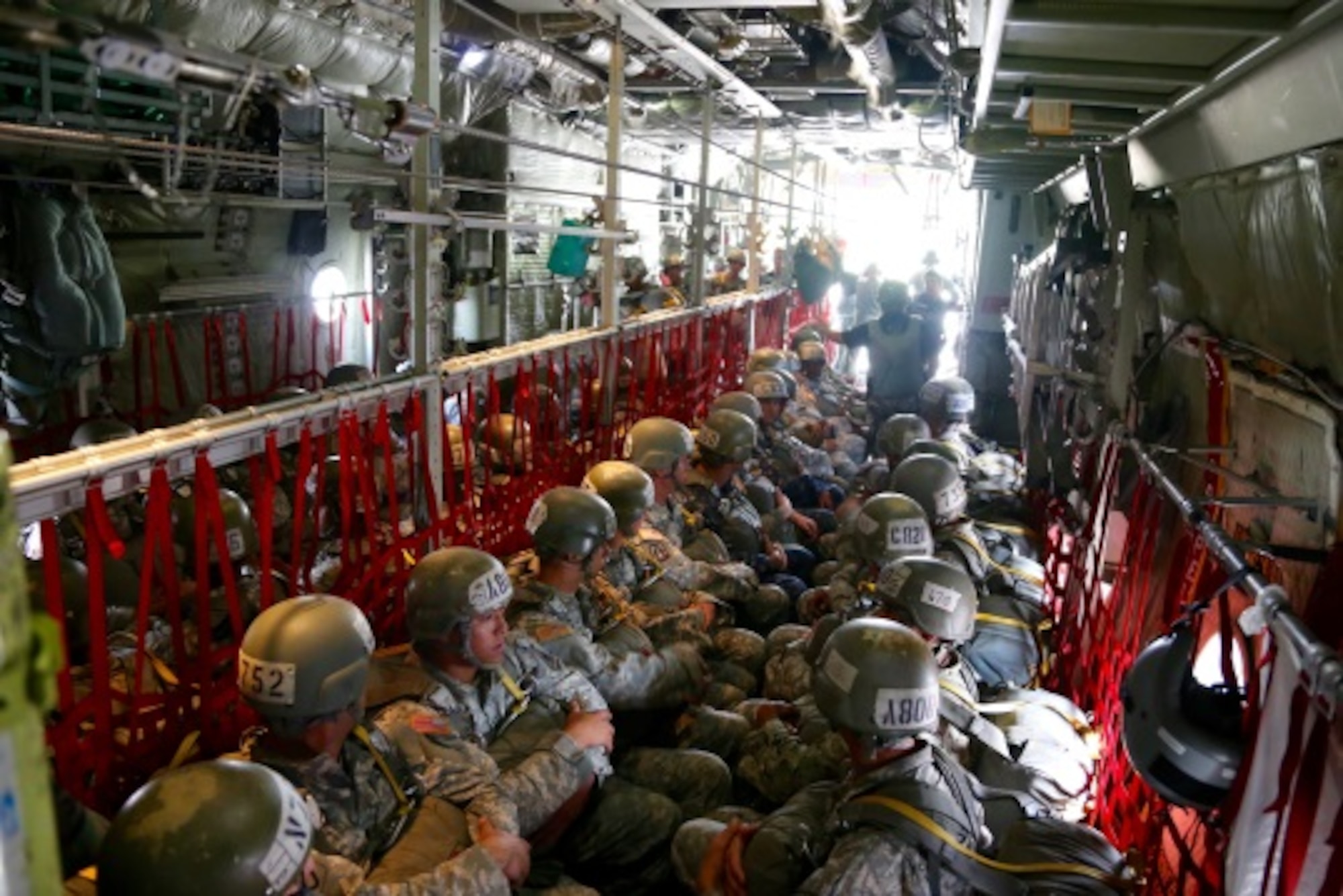 Basic Airborne Course students sit inside a C-130H as they wait for takeoff and the chance to exit the aircraft by jumping from it at Fort Benning, Ga. July 13, 2015. Jumps are usually conducted at around 1,250 feet. (U.S. Air Force photo/Maj. Mark Withee)