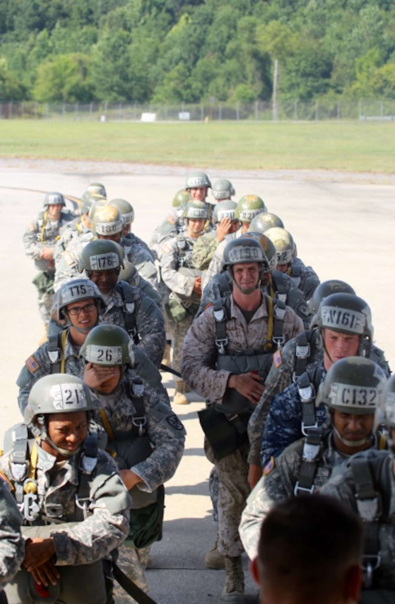 Student paratroopers prepare to board a C-130 aircraft at Fort Benning, Ga. July 13, 2015. Once airborne, students will receive instructions from members of the 1st Battalion, 507th Parachute Infantry Regiment. The 1-507th trains and prepares paratroopers to conduct airborne operations anywhere Department of Defense wide. (U.S. Air Force photo/Maj. Mark Withee)