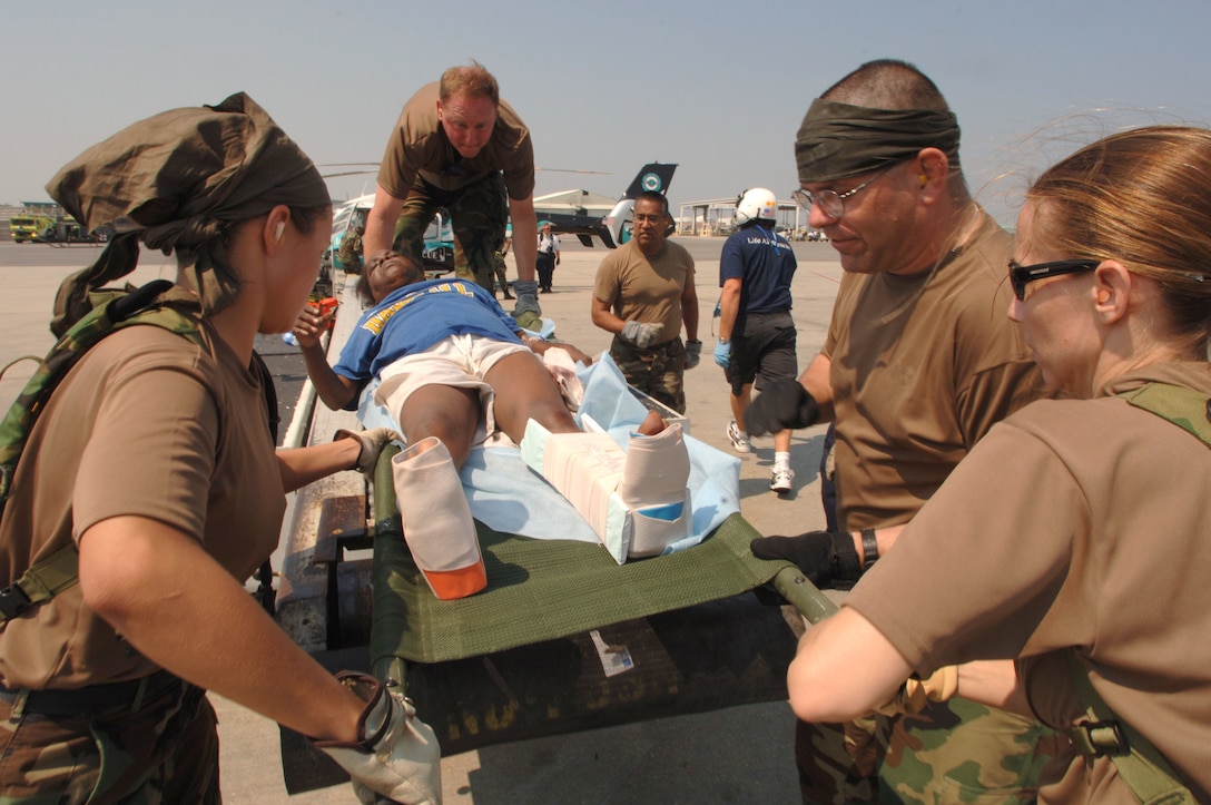 Crews carry Hurricane Katrina victims who were airlifted into New Orleans International Airport in New Orleans, Sept. 2, 2005, via U.S. military transport. Emergency medical crews were on hand to provide care to those with special needs. U.S. Air Force photo by Staff Sgt. Jacob N. Bailey