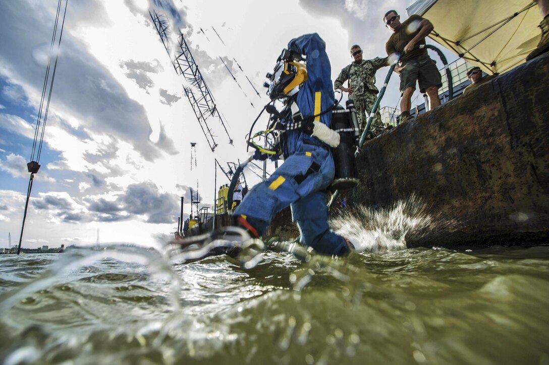 Navy Petty Officer 3rd Class Kevin Kollar jumps into the Savannah River to conduct salvage operations on SCC Georgia steamship in Savannah, Ga., Aug. 18, 2015. Kollar is a diver assigned to Mobile Diving and Salvage Unit 2. U.S. Navy photo by Petty Officer 1st Class Blake Midnight