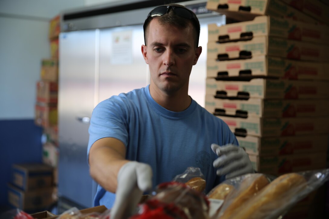 Capt. Elliot Parks, a Fairfax, Va., native and company commander with I Marine Expeditionary Force Headquarters Group, I Marine Expeditionary Force, organizes food at the Fallbrook Food Pantry in Fallbrook, Calif., on August 15, 2015. The Fallbrook Food Pantry collects food donations from local businesses and redistributes the food to families going through difficult times. (USMC photo by Pfc. Devan K. Gowans)