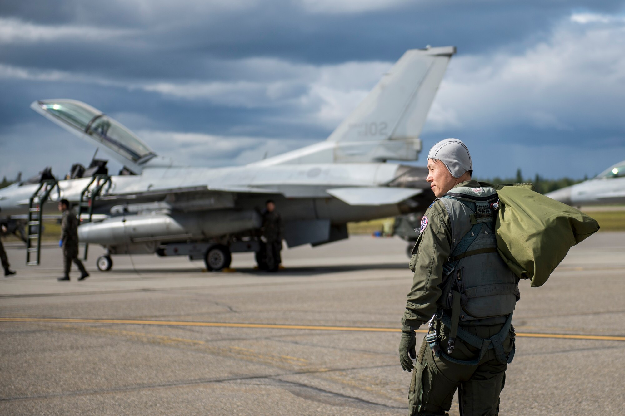 Republic of Korea Air Force (ROKAF) Maj. Lee Dong Seop, a ROKAF F-16D Fighting Falcon pilot, carries equipment to his aircraft, Aug. 11, 2015, prior to the launch of a RED FLAG-Alaska (RF-A) 15-3 sortie from Eielson Air Force Base, Alaska. The ROKAF flew a squadron of F-16Ds across the Pacific Ocean to train in the Joint Pacific Alaska Range Complex’s 67,000 square miles of airspace for two weeks of realistic combat flying training throughout RF-A 15-3. (U.S. Air Force photo by 1st Lt. Elias Zani/Released)