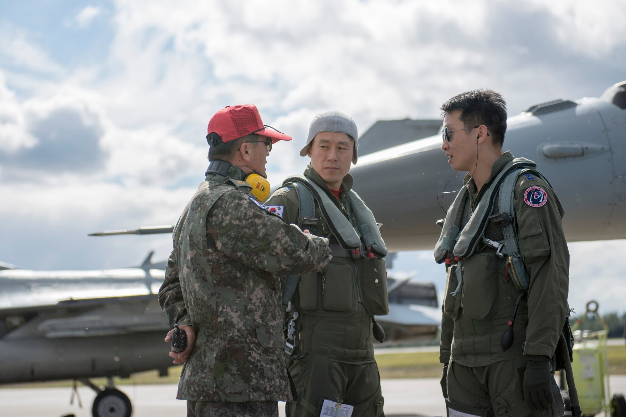 Republic of Korea Air Force (ROKAF) Majs. Lee Dong Seop and Lee Jong Won, both ROKAF F-16D Fighting Falcon pilots, receive preflight instruction from Warrant Officer Dongjun Lee, a ROKAF maintenance officer, Aug. 11, 2015, prior to the launch of a RED FLAG-Alaska (RF-A) 15-3 sortie from Eielson Air Force Base, Alaska. The ROKAF flew a squadron of F-16Ds across the Pacific Ocean to train in the Joint Pacific Alaska Range Complex’s 67,000 square miles of airspace for two weeks of realistic combat flying training throughout RF-A 15-3. (U.S. Air Force photo by 1st Lt. Elias Zani/Released)