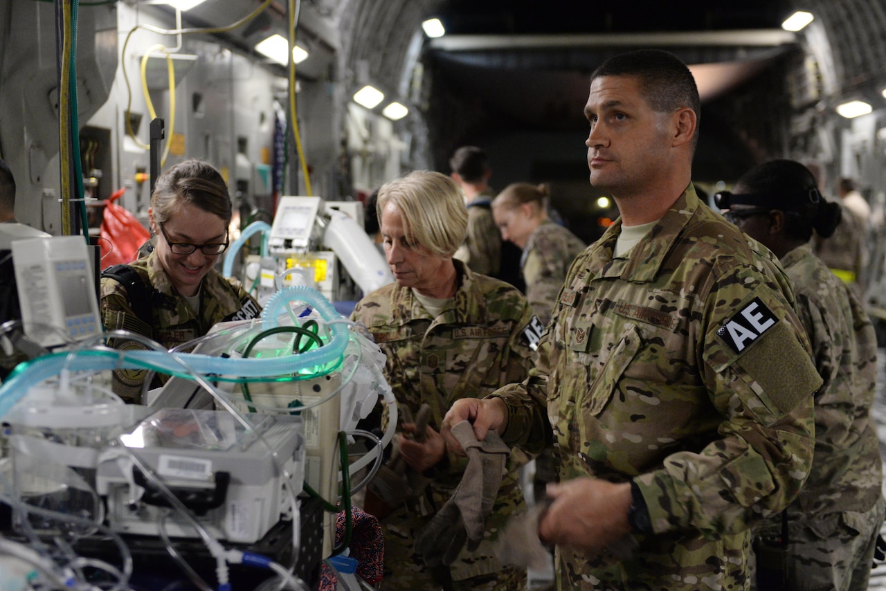 North Carolina Air National Guard Tech. Sgt. Russell McLamb, an aeromedical evacuation technician, helps load an injured service member onto a C-17 Globemaster III on the flight line at Bagram Airfield, Afghanistan, Aug. 8, 2015. McLamb, a veteran of three branches of the military, is deployed from the 156th Aeromedical Evacuation Squadron, based in Charlotte, N.C., to the 455th Expeditionary Aeromedical Evacuation Squadron at Bagram. U.S. Air Force photo by Maj. Tony Wickman