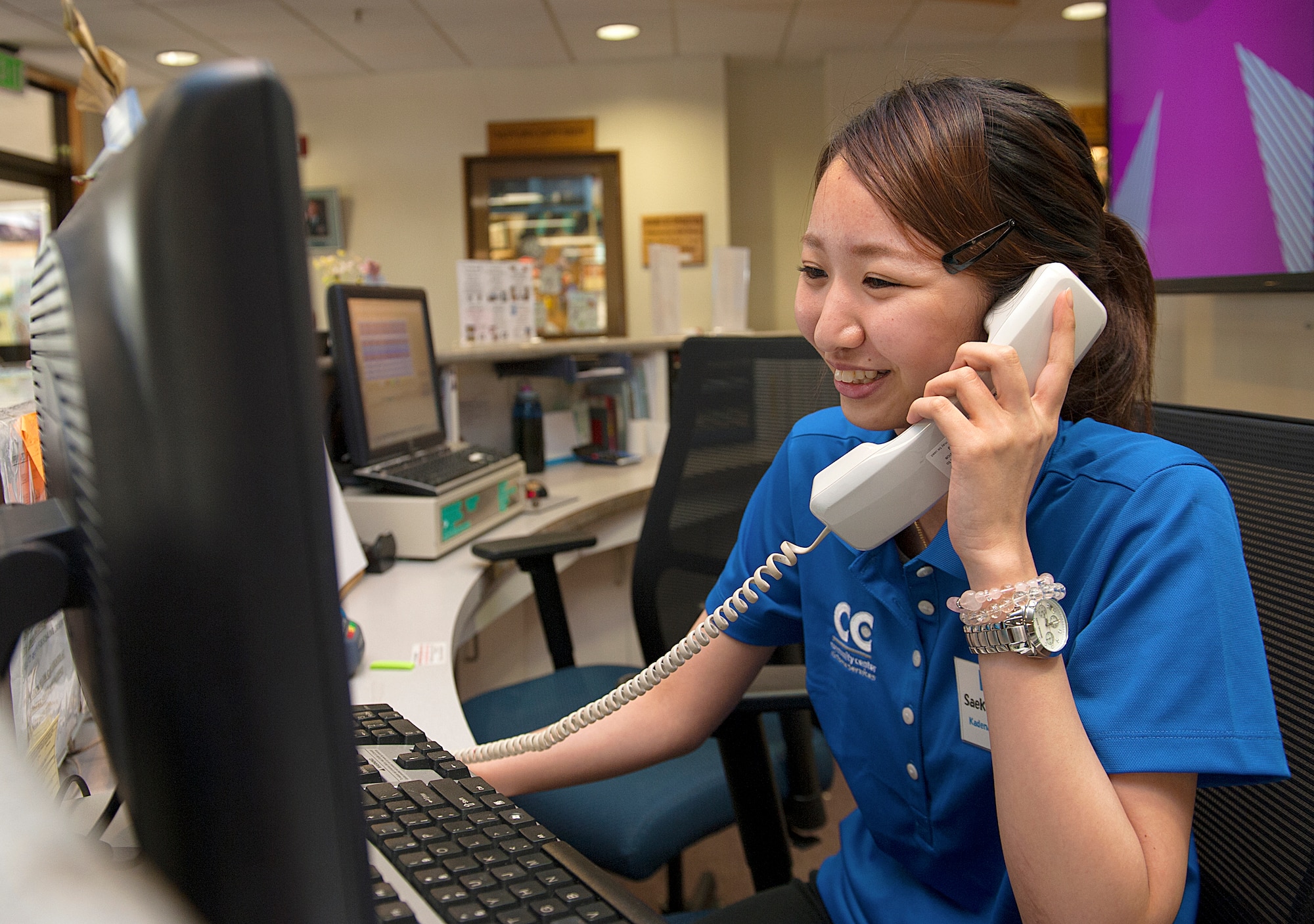 Saeko Minamizawa, Kadena Language Institute student, answers a phone call at the Schilling Community Center on Kadena Air Base, Japan, Aug. 20, 2015. Ten KLI students participated in an internship program working in different facilities throughout the base and practicing their English speaking skills in a professional environment. (U.S. Air Force photo by Naoto Anazawa)
