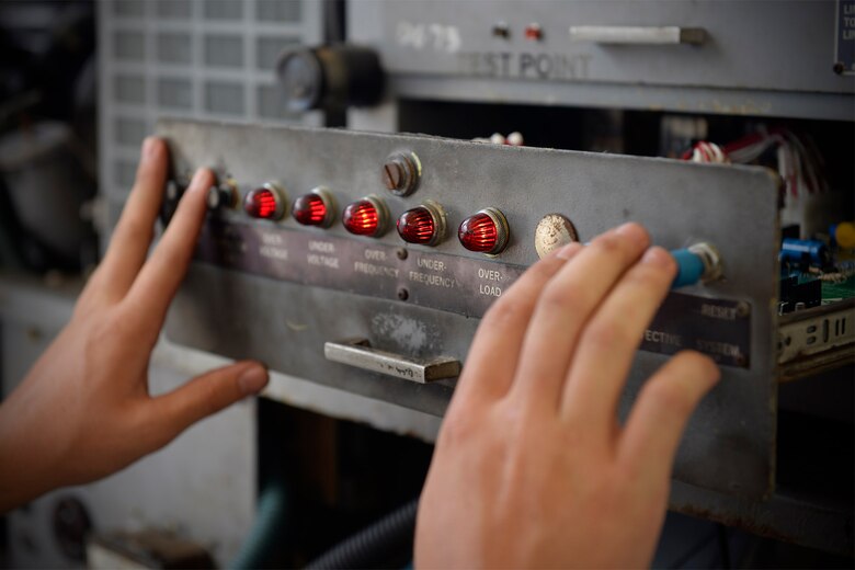 Airman 1st Class Jacob Holley, aerospace ground equipment journeyman and deployed member of the 36th Maintenance Squadron, checks indicator lights on a power generator’s control console Aug. 12, 2015, at Andersen Air Force Base, Guam. The AGE maintainers care for a variety of essential equipment used during aircraft maintenance and preflight operations. (U.S. Air Force photo by Staff Sgt. Alexander W. Riedel/Released)  