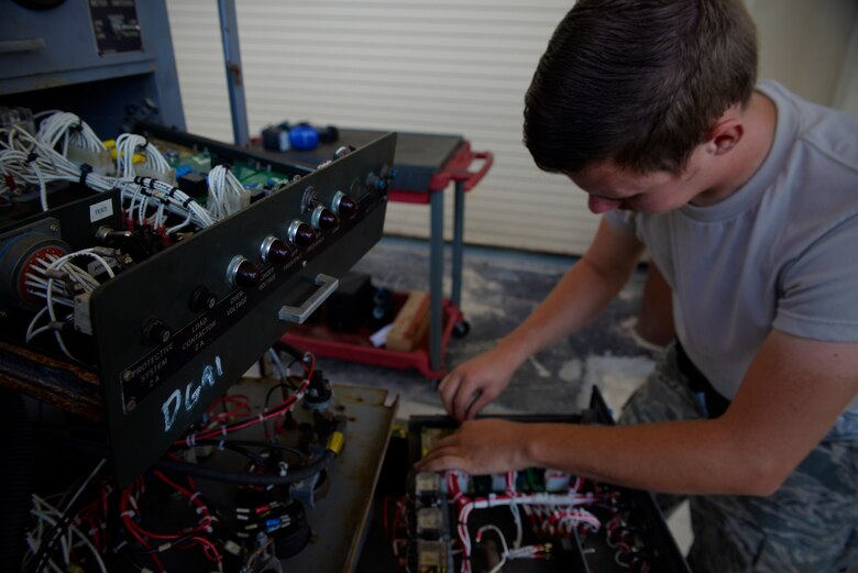 Airman 1st Class Jacob Holley, aerospace ground equipment journeyman and deployed member of the 36th Maintenance Squadron, repairs wiring on a power generator’s control console Aug. 12, 2015, at Andersen Air Force Base, Guam. The AGE maintainers care for a variety of essential equipment used during aircraft maintenance and preflight operations. (U.S. Air Force photo by Staff Sgt. Alexander W. Riedel/Released)  
