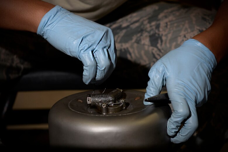 Airman 1st Class Michael Tallada, aerospace ground equipment apprentice and Guam native assigned to the 36th Maintenance Squadron, threads safety wire on a diesel generator exhaust part Aug. 12, 2015, at Andersen Air Force Base, Guam. The AGE maintainers care for a variety of essential equipment used during aircraft maintenance and preflight operations. (U.S. Air Force photo by Staff Sgt. Alexander W. Riedel/Released)  
