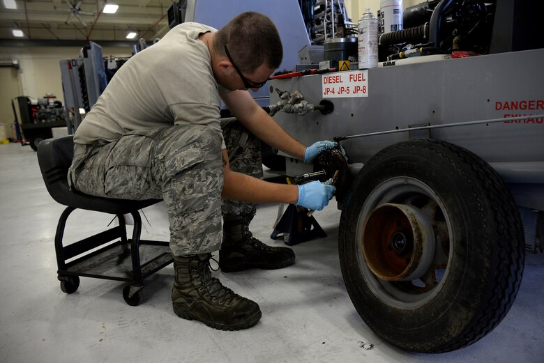 Senior Airman David Rippberger, aerospace ground equipment journeyman and deployed member of the 36th Maintenance Squadron, cleans brake pads on a towable air compressor Aug. 12, 2015, at Andersen Air Force Base, Guam. The maintainers regularly test brake parts for corrosion to ensure safety. (U.S. Air Force photo by Staff Sgt. Alexander W. Riedel/Released)  