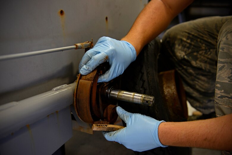 Senior Airman David Rippberger, aerospace ground equipment journeyman and deployed member of the 36th Maintenance Squadron, cleans brake pads on a towable air compressor Aug. 12, 2015, at Andersen Air Force Base, Guam. Every two years the maintainers test brake parts for corrosion to ensure safety. (U.S. Air Force photo by Staff Sgt. Alexander W. Riedel/Released)  