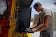Senior Airman Matthew Platz, aerospace ground equipment journeyman and deployed member of the 36th Maintenance Squadron, references technical orders while working on a defunct hydraulics pressure pump Aug. 12, 2015, at Andersen Air Force Base, Guam. The maintainers care for a variety of essential equipment used during maintenance and preflight operations. (U.S. Air Force photo by Staff Sgt. Alexander W. Riedel/Released) 