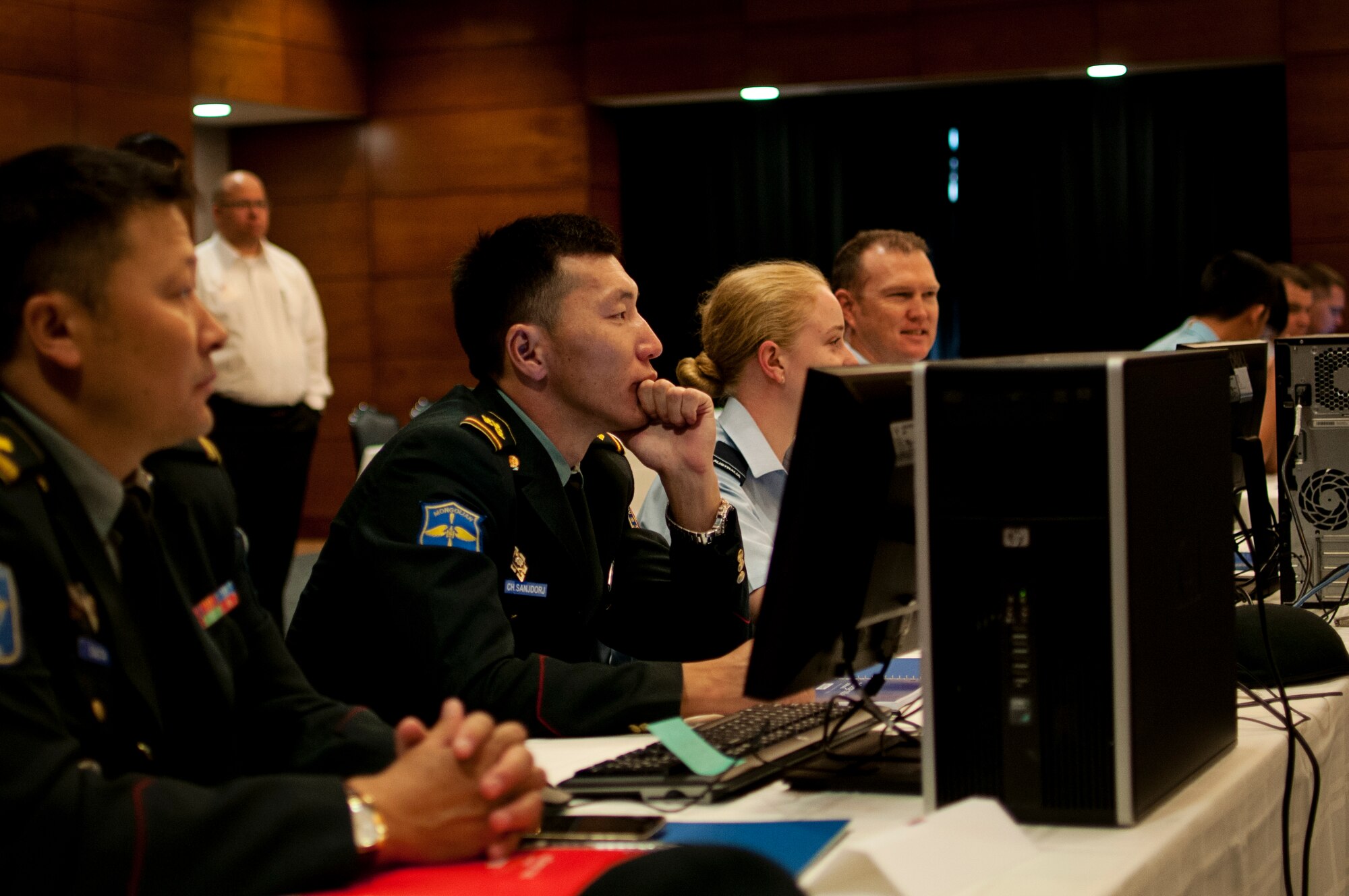 Participants of the command post exercise portion of the Pacific Airlift Rally gather for an opening speech on Joint Base Elmendorf-Richardson, Aug. 25. The Pacific Airlift Rally is a bi-annual, multinational military-airlift symposium for nations in the Indo-Pacific Region and is hosted by the Pacific Air Forces. (U.S. Air National Guard photo by Tech. Sgt. Alicia Halla)