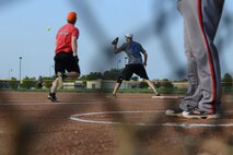 A 22nd Civil Engineer Squadron Airman is thrown out after hitting a ground ball during the second inning of the McConnell intramural softball championship game, Aug. 18, 2015, at McConnell Air Force Base, Kan. The 22nd CES team was scoreless going into the third inning against the 22nd Aircraft Maintenance Squadron. (U.S. Air Force photo by Airman 1st Class Christopher Thornbury)