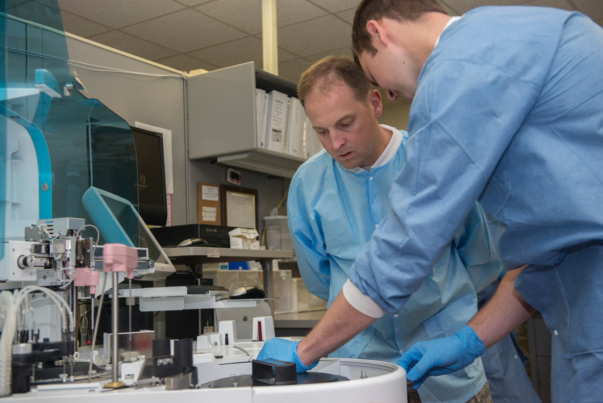 Senior Airman Mason Livermore, a 49th Medical Group medical laboratory technician, demonstrates the process of performing chemistry analysis on blood samples at Holloman Air Force Base, N.M, Aug. 19 to Col. Robert Kiebler, 49th Wing commander. Every week the wing commander and the wing command chief make a face-to-face and hands-on visit to different parts of the base to get to know airmen and learn about their contribution to the mission. This week’s trip to the 49th Medical Group was focused on the medical laboratory where they learned about phlebotomy, urinalysis, hematology and chemistry. (U.S. Air Force photo by Senior Airman Aaron Montoya)