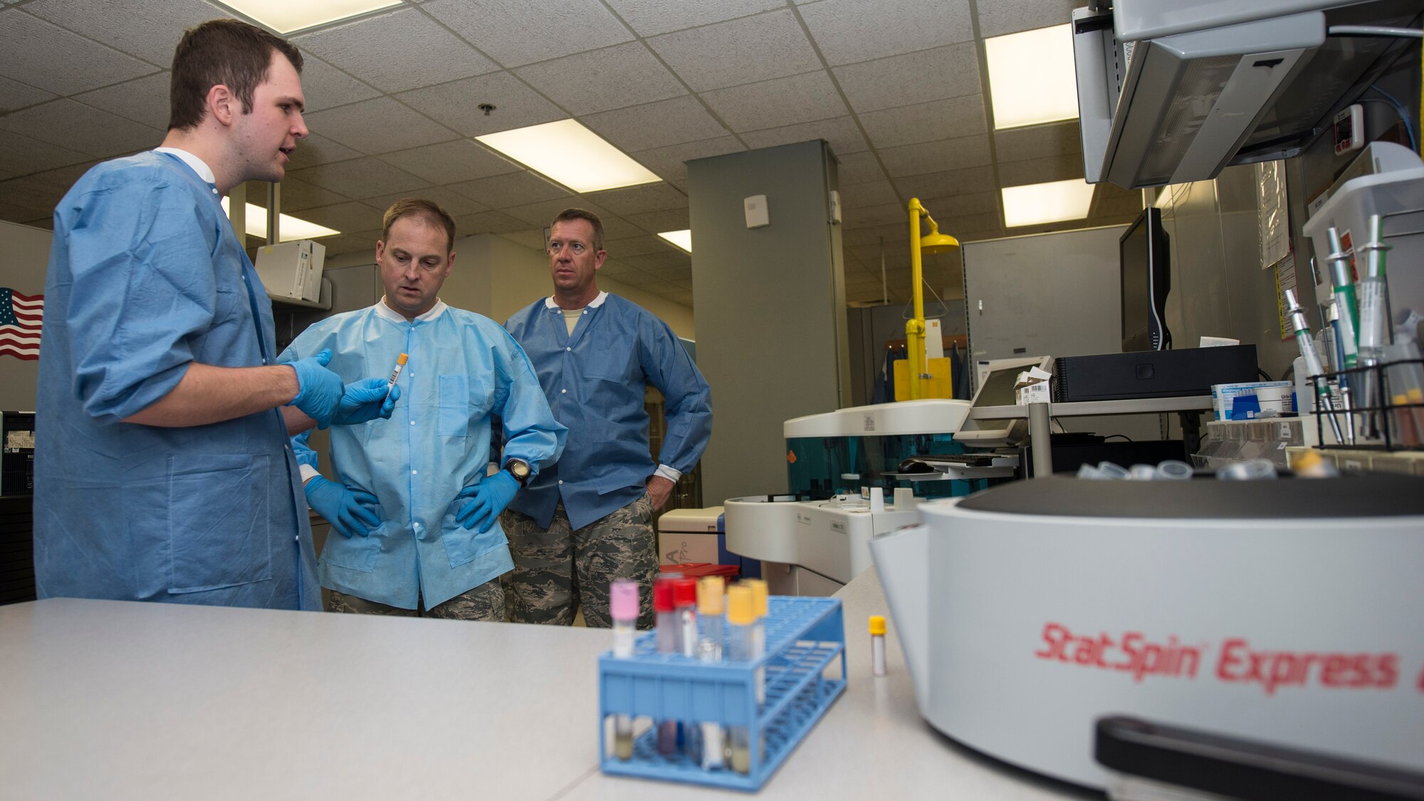 Senior Airman Mason Livermore, a 49th Medical Group medical laboratory technician, describes the process of performing chemistry analysis on blood samples at Holloman Air Force Base, N.M, Aug. 19 to Col. Robert Kiebler, 49th Wing commander, and Chief Master Sgt. Scott Loescher, 49th Wing command chief. Every week Kiebler and Loescher get an in-depth and hands-on look at various jobs performed by airmen around the base. This week’s trip to the 49th Medical Group was focused on the medical laboratory where they learned about phlebotomy, urinalysis, hematology and chemistry. (U.S. Air Force photo by Senior Airman Aaron Montoya)