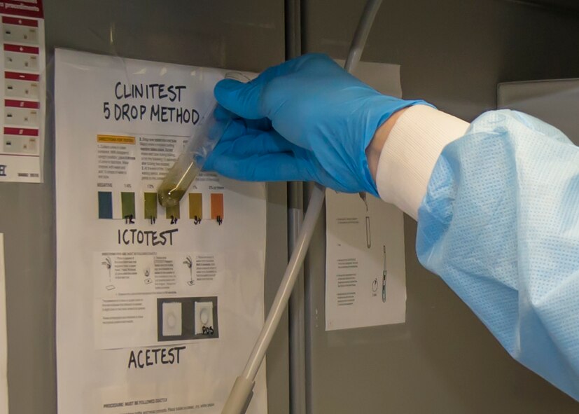 Col. Robert Kiebler, the 49th Wing commander, compares a urine sample after performing a test during his familiarization trip to the 49th Medical Group at Holloman Air Force Base, N.M., Aug. 19. Every week the wing commander and the wing command chief visit a different unit to familiarize themselves with the various jobs performed on base, and to get hands-on experience performing the job. This week’s trip to the 49th Medical Group was focused on the medical laboratory where they learned about phlebotomy, urinalysis, hematology and chemistry. (U.S. Air Force photo by Senior Airman Aaron Montoya)