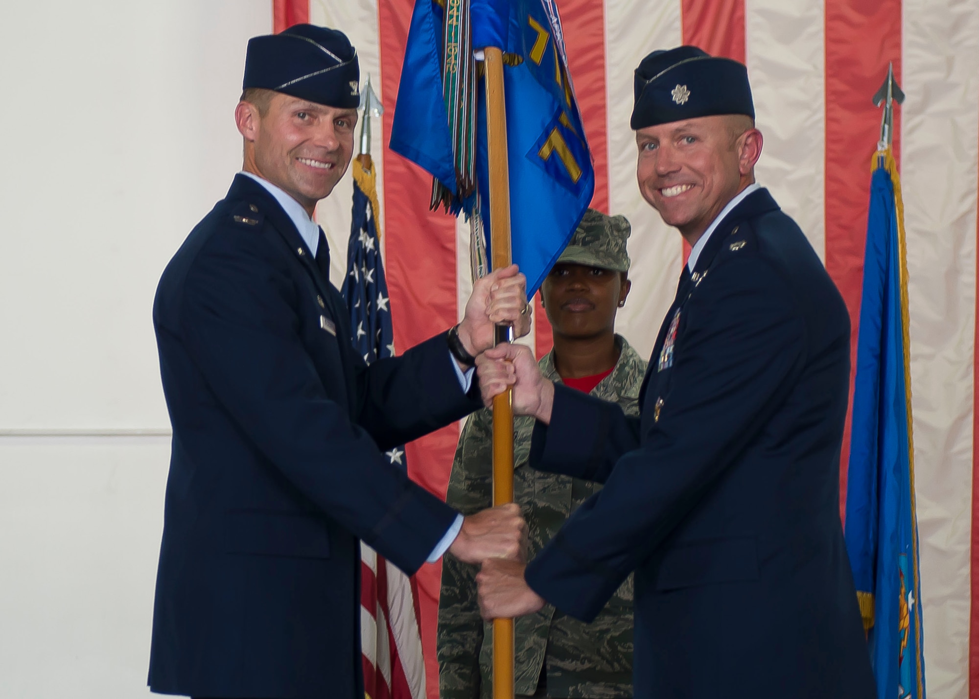 U.S. Air Force Col. Larry Broadwell, 1st Operations Group commander, left, passes a squadron guidon to Lt. Col. Brian Coyne, right, who assumed command of the 71st Fighter Training Squadron during a reactivation ceremony at Langley Air Force Base, Va., Aug. 21, 2015. Originally formed in December 1940 as the 71st Pursuit Squadron, the unit was re-designated during the ceremony and will now aid the 1st Fighter Wing by providing realistic adversarial air training support. (U.S. Air Force photo by Staff Sgt. John D. Strong II/Released)