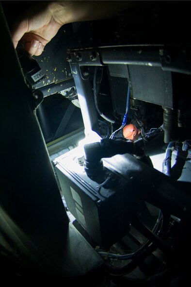 A crew chief from the 41st Helicopter Maintenance Unit performs post-flight inspections underneath the cockpit seat in an HH-60G Pave Hawk Aug. 20, 2015, at Moody Air Force Base, Ga. Every action the crew chiefs execute follows a technical order, a step-by-step guide, to ensure all maintenance is performed correctly. (U.S. Air Force photo by Airman 1st Class Dillian Bamman/Released)