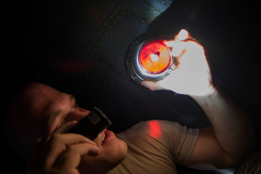 U.S. Air Force Airman 1st Class Matthew Whitmer, 41st Helicopter Maintenance Unit crew chief, inspects an HH-60G Pave Hawk’s bottom light during post-flight inspections Aug. 20, 2015, at Moody Air Force Base, Ga. The 41st HMU performs routine maintenance on the Pave Hawks to ensure their mission effectiveness and readiness. (U.S. Air Force photo by Airman 1st Class Dillian Bamman/Released)