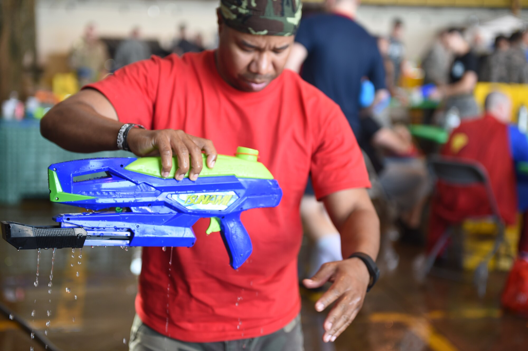 Buckley firefighters spray Combat Dining Out attendees during the event Aug. 21, 2015, at Hangar 909 on Buckley Air Force Base, Colo. Combat Dining Out is an annual event that included water fights, an obstacle course, a grog bowl, food, music, and is a spin on the more formal Combat Dining In, allowing spouses and guests to attend. (U.S. Air Force photo by Airman 1st Class Samantha Meadors/Released)
