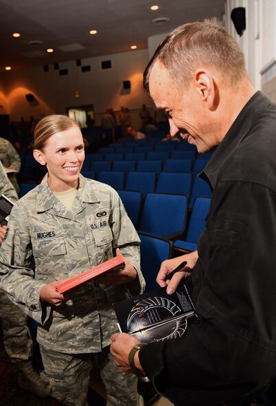 Staff Sgt. Sarah Hughes, 932nd Airlift Wing Security Forces team member, shares a smile and laugh with Lt. Col. Dave Grossman, former Ranger and retired psychology professor at West Point, while having her book signed by the author, Aug. 21, 2015, Scott Air Force Base, Illinois.  The lecture from Grossman was the final event for a week of resiliency training for a few Airman and civilian employees from the 932nd Airlift Wing.  The training was a joint effort with active, reserve and civilians from various agencies at Scott Air Force Base. (U.S. Air Force photo / Christopher Parr)