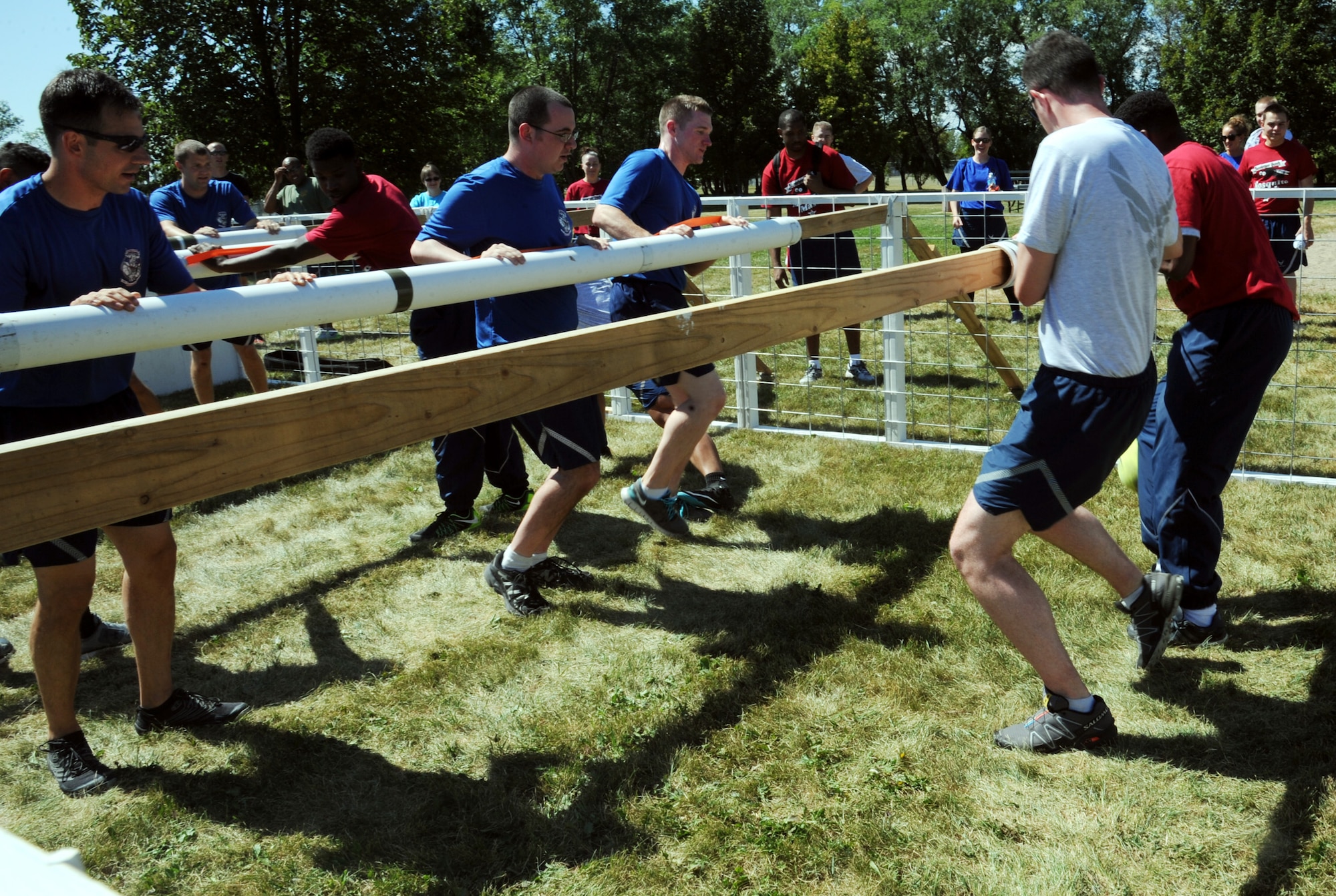 Airmen from the 319th Communications Squadron and 319th Logistics Readiness Squadron play in a human foosball event Aug. 20, during Summer Bash 2015 at Grand Forks Air Force Base, North Dakota. Summer Bash is an annual event at Grand Forks AFB, providing friendly compeitition between squadrons and comraderie amongst Airmen. (U.S. Air Force photo by Senior Airman Desiree Economides/Released)