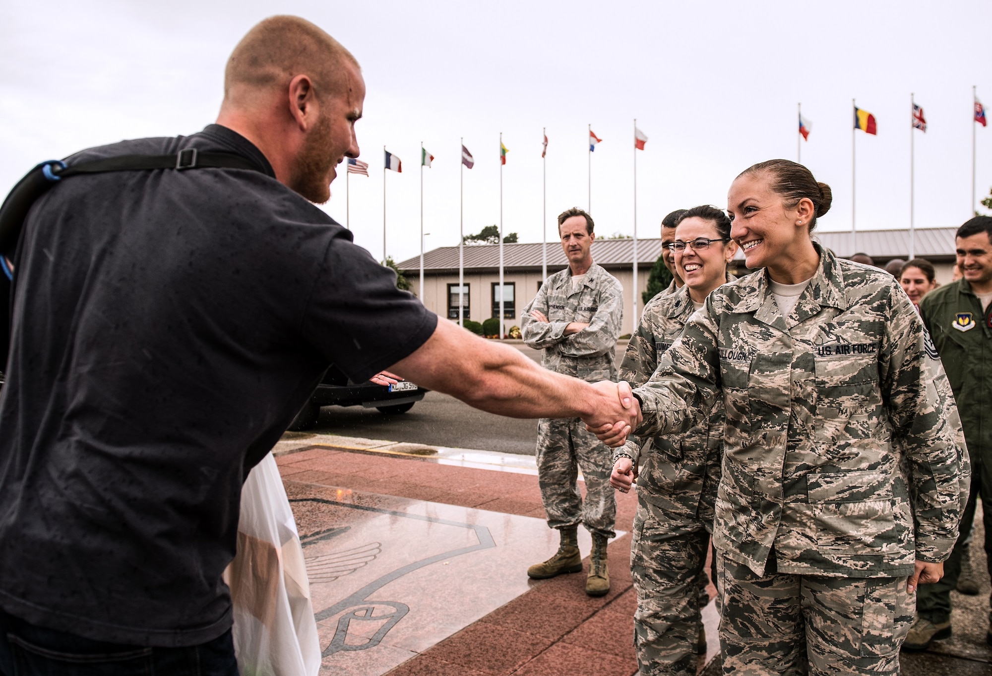 U.S. Air Force Airman 1st Class Spencer Stone shakes Tech. Sgt. Amanda McCullough, 86th Airlift Wing protocol, upon his arrival to Ramstein Air Base, Germany, Aug. 24. 2015. Stone, along with childhood friends Aleksander Skarlatos and Anthony Sadler, was recently honored by French President François Hollande with the French Legion of Honour for subduing an armed gunman when he entered their train carrying an assault rifle, a handgun and a box cutter. Stone is an ambulance service technician with the 65th Medical Operations Squadron stationed at Lajes Field, Azores. (U.S. Air Force Photo by Staff Sgt. Sara Keller)