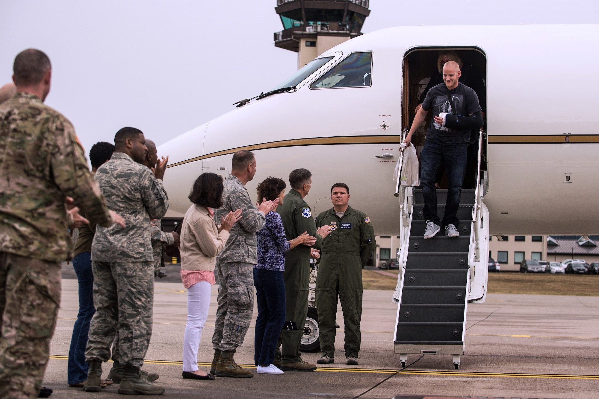 Airman 1st Class Spencer Stone is greeted with a "Heroic Welcome" as he and Oregon National Guardsman Aleksander Skarlatos arrive at Ramstein Air Base, Germany, Aug. 24. 2015. More than 500 Airmen and their families came out to line the streets and thank Stone and his friends for their bravery. Stone arrived at Ramstein while in transit to Landstuhl Regional Medical Center for follow-on medical treatment. Stone received multiple injuries, all of which were non-life threatening, while subduing an armed gunman on a train traveling from Amsterdam to Paris. Stone is an ambulance service technician with the 65th Medical Operations Squadron stationed at Lajes Field, Azores. (U.S. Air Force Photo/Staff Sgt. Sara Keller)