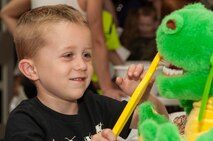 A young member of Team Seymour learns about proper dental care while going through a mock personnel deployment function line, Aug. 21, 2015, at Seymour Johnson Air Force Base, North Carolina. While going through the line, kids got to meet with finance, legal, dental, public health, and the chaplain to prepare them for their mock deployments. (U.S. Air Force photo/Airman Shawna L. Keyes)
